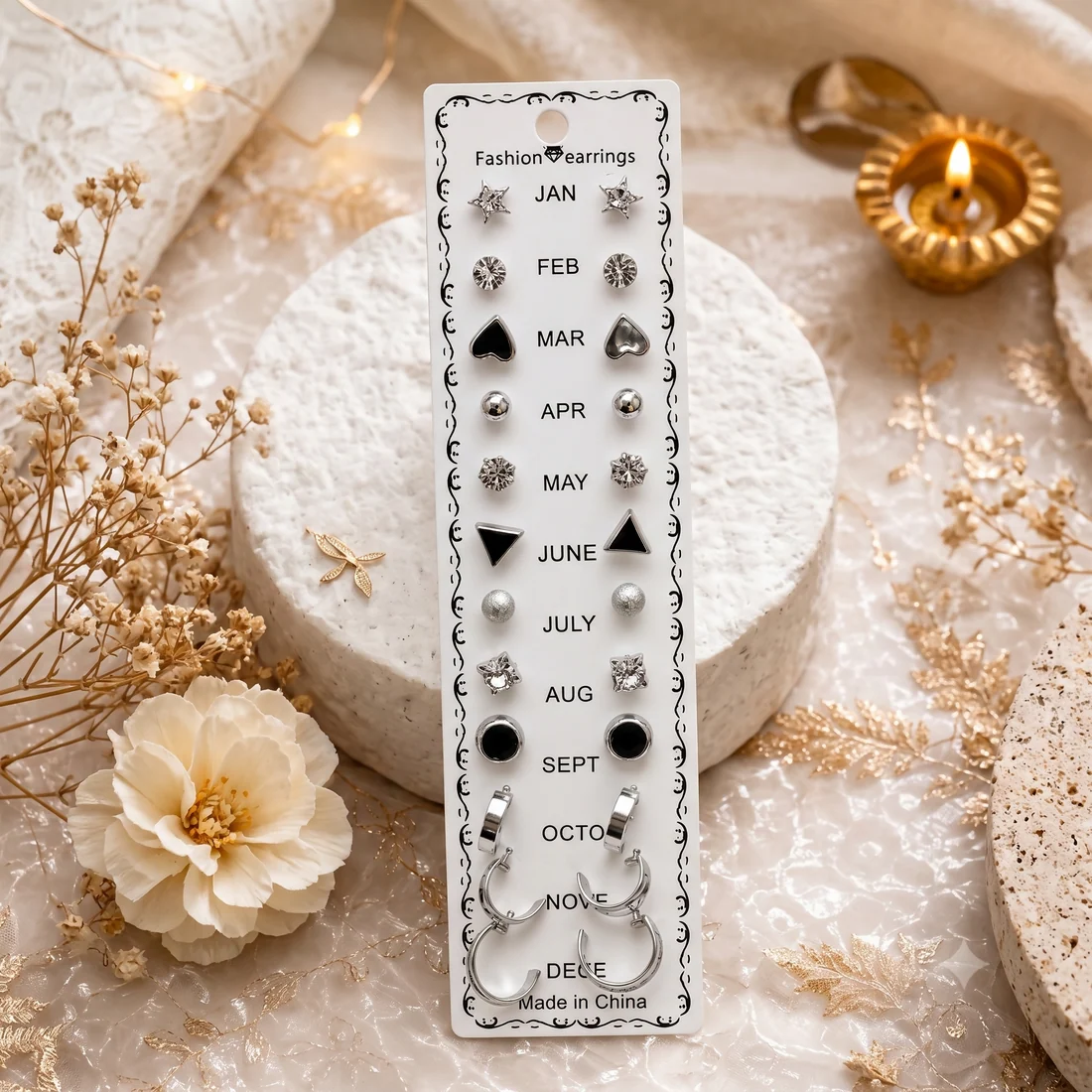 Monthly 12 Pairs Earring Set A Silver Finish with Various Geometric Studs and Huggie Hoops.